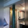 The severely corroded lally column experienced a significant loss of load-bearing capacity, resulting in inadequate structural support and contributing to noticeable settlement and sagging of the floor system above.