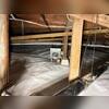 The completed encapsulation system covers the previously exposed crawl space floor and extends around the perimeter to help separate the space beneath the home from ground moisture.