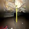 A measurement documents the limited clearance inside this Manhattan Beach crawl space before the encapsulation project began. The exposed soil and insulation show the original conditions beneath the home.