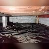 This crawl space was covered with a black tarp that does nothing to protect it and the concrete wall was not stable. That's why our team had to come and address these issues.