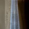 A close-up look at the trench drain that was installed by the basement entrance to collect any water that seeps through from rain.