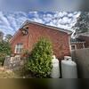 Stair-step cracks along the brick exterior were a visible symptom of foundation movement. Cracks like these can develop as sections of the foundation settle and shift, causing separation along the mortar joints.