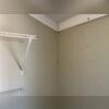 A vertical crack is visible along an interior wall corner, with additional separation near the ceiling trim. This photo documents an interior condition at the Globe home before the SmartJack support installation.