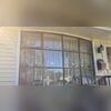 Before: Faded, weathered dark trim surrounding the front bay window needed surface preparation.