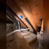 Existing passive radon piping in the attic after the system was completed and extended through the roof.