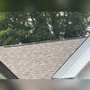 Ridge ventilation was installed along the garage roof's peak to help warm, moisture-laden air escape from the space beneath the roof. When supported by adequate intake airflow, this ventilation helps manage heat and moisture buildup.