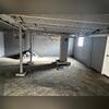 The existing lally columns were inadequately supporting the floor system, particularly in the area adjacent to the chimney. Evidence of this was visible in the floor joists, which exhibited noticeable deflection, indicating that the framing members were experiencing excessive loading and...