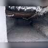 The attached concrete crawl space is part of the home's foundation and is included in the radon mitigation system's coverage.