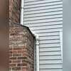 The existing elbow above the radon fan shows visible damage and requires replacement to restore a secure pipe connection.