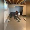 In this photo you can see the pieces of our drainage system that would be installed along the walls of the basement. This collects water seeping through the joint of the wall and floor, instead sending it to the sump pump.