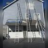 Safely reaching high-peaked gables with professional ladder setups for thorough prep work above the garage.