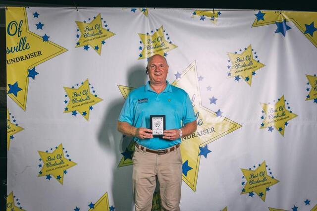 Kerry Gant, Design Specialist at Frontier Foundation, holds the award for "Best Basement Waterproofing Company." 
